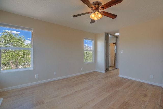 2308 Animas Ct NE, Rio Rancho, NM 87144 - empty room featuring light wood-style floors, a ceiling fan, plenty of natural light, and baseboards