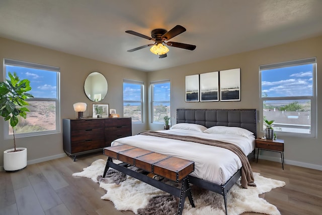 2308 Animas Ct NE, Rio Rancho, NM 87144 - bedroom featuring baseboards, light wood-style floors, and ceiling fan