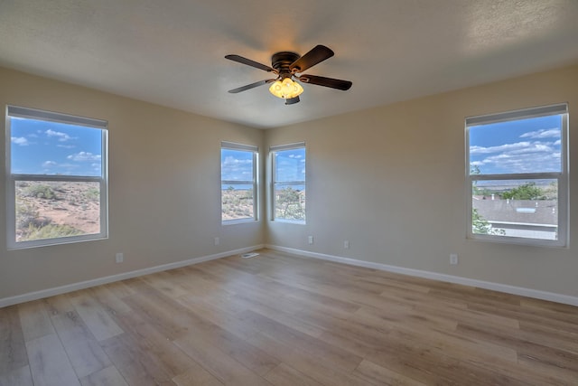 2308 Animas Ct NE, Rio Rancho, NM 87144 - spare room with light wood-style floors, baseboards, and ceiling fan