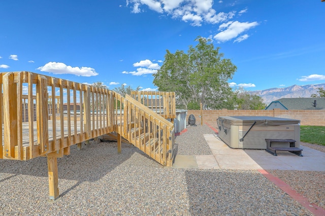 2308 Animas Ct NE, Rio Rancho, NM 87144 - view of home's community featuring a hot tub, a fenced backyard, and a deck with mountain view