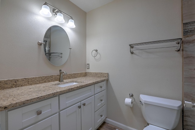 2308 Animas Ct NE, Rio Rancho, NM 87144 - bathroom with vanity, toilet, baseboards, and wood finished floors