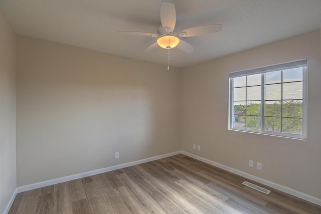 2308 Animas Ct NE, Rio Rancho, NM 87144 - spare room featuring wood finished floors, baseboards, and ceiling fan