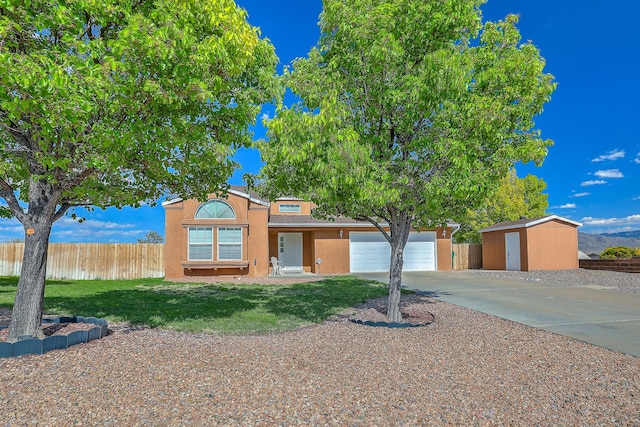 2308 Animas Ct NE, Rio Rancho, NM 87144 - view of front of house featuring concrete driveway, stucco siding, a storage unit, an attached garage, and an outdoor structure