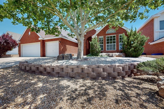 8720 Oakcrest Pl NW, Albuquerque, NM 87114 - traditional home with concrete driveway, brick siding, and an attached garage