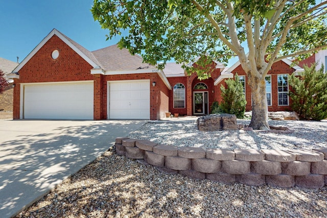 8720 Oakcrest Pl NW, Albuquerque, NM 87114 - view of front of house featuring concrete driveway, brick siding, and an attached garage