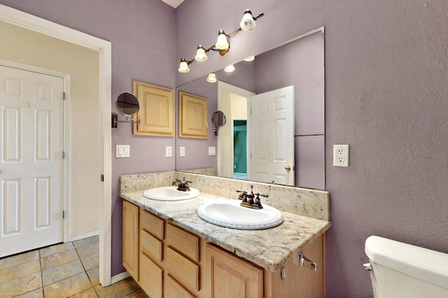8720 Oakcrest Pl NW, Albuquerque, NM 87114 - bathroom with toilet, double vanity, and tile patterned floors