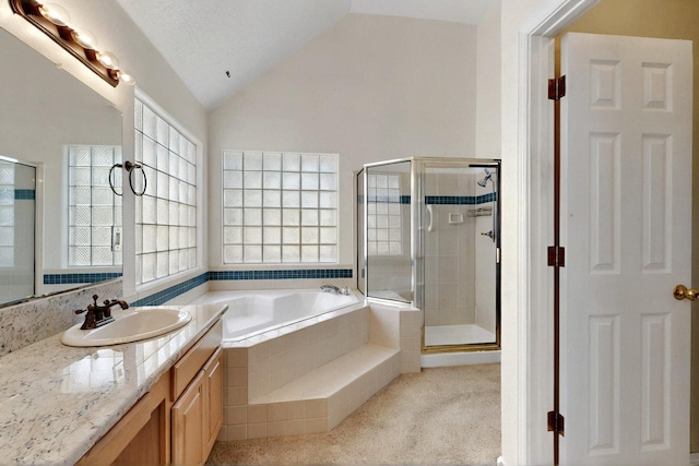 8720 Oakcrest Pl NW, Albuquerque, NM 87114 - full bath with vaulted ceiling, a shower stall, a bath, vanity, and healthy amount of natural light