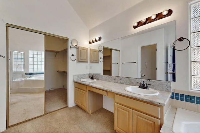 8720 Oakcrest Pl NW, Albuquerque, NM 87114 - full bathroom with vaulted ceiling, double vanity, and a garden tub