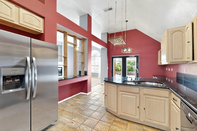 8720 Oakcrest Pl NW, Albuquerque, NM 87114 - kitchen with stainless steel fridge with ice dispenser, light brown cabinetry, a sink, vaulted ceiling, and dishwasher