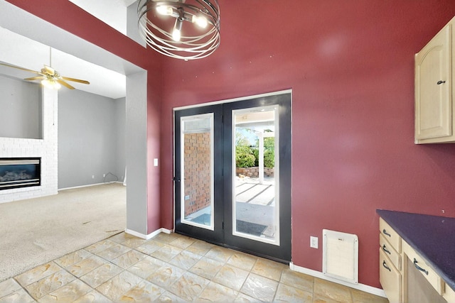 8720 Oakcrest Pl NW, Albuquerque, NM 87114 - unfurnished dining area with baseboards, a ceiling fan, a fireplace, light colored carpet, and french doors