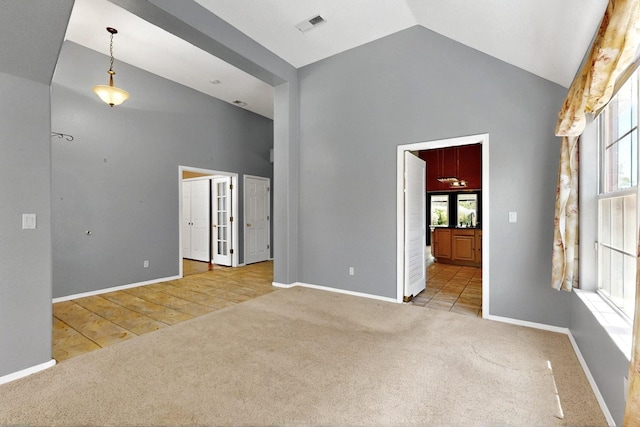 8720 Oakcrest Pl NW, Albuquerque, NM 87114 - carpeted empty room featuring high vaulted ceiling and baseboards