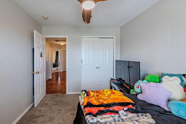 10500 Trieste Ct NW, Albuquerque, NM 87114 - carpeted bedroom featuring a closet, baseboards, a textured ceiling, and ceiling fan
