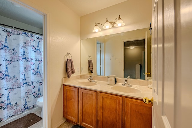 10500 Trieste Ct NW, Albuquerque, NM 87114 - bathroom featuring toilet, double vanity, and a shower with curtain