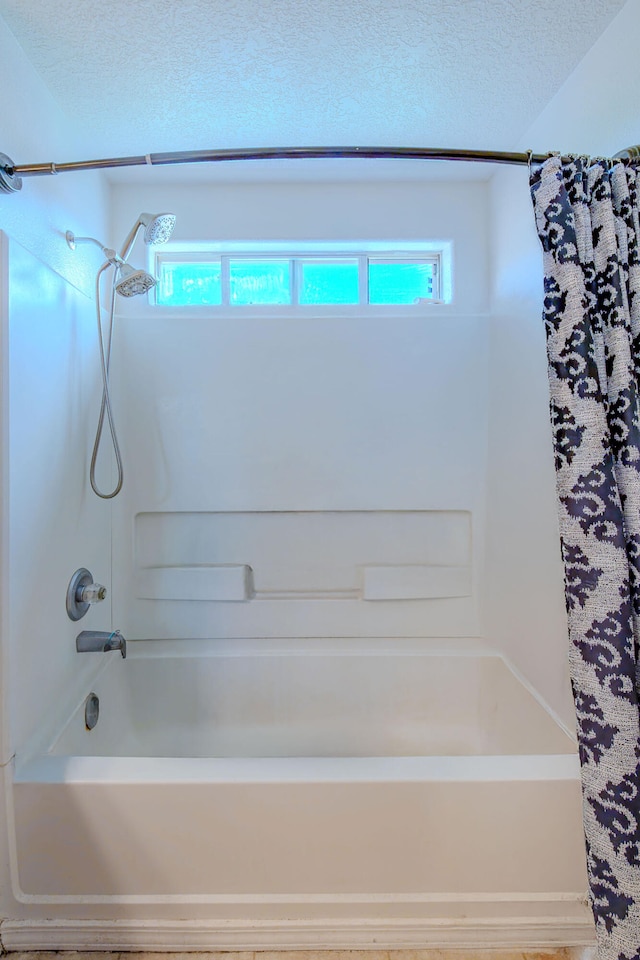 10500 Trieste Ct NW, Albuquerque, NM 87114 - bathroom featuring tub / shower combination and a textured ceiling