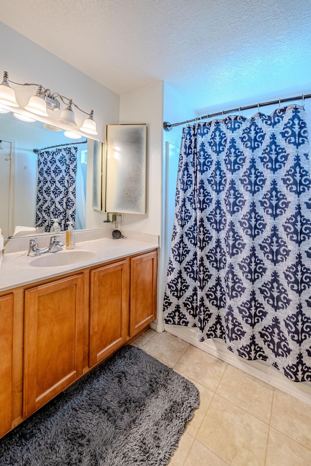 10500 Trieste Ct NW, Albuquerque, NM 87114 - bathroom featuring tile patterned floors, vanity, a textured ceiling, and curtained shower