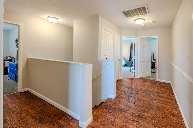 10500 Trieste Ct NW, Albuquerque, NM 87114 - corridor with an upstairs landing, wood finished floors, a textured ceiling, and baseboards