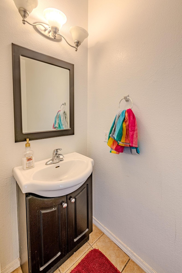 10500 Trieste Ct NW, Albuquerque, NM 87114 - bathroom with baseboards, vanity, and tile patterned floors