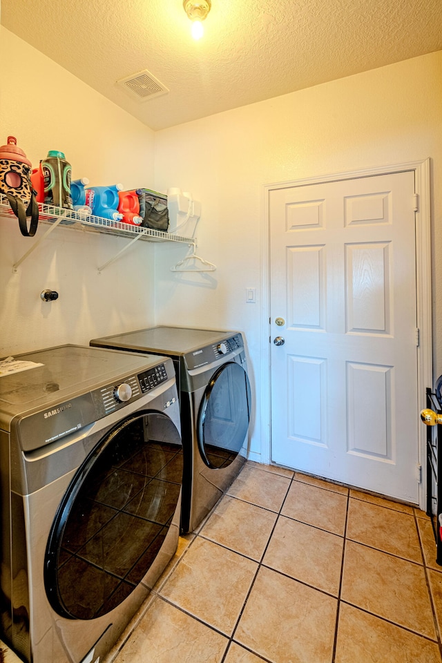 10500 Trieste Ct NW, Albuquerque, NM 87114 - washroom with independent washer and dryer, light tile patterned floors, and a textured ceiling