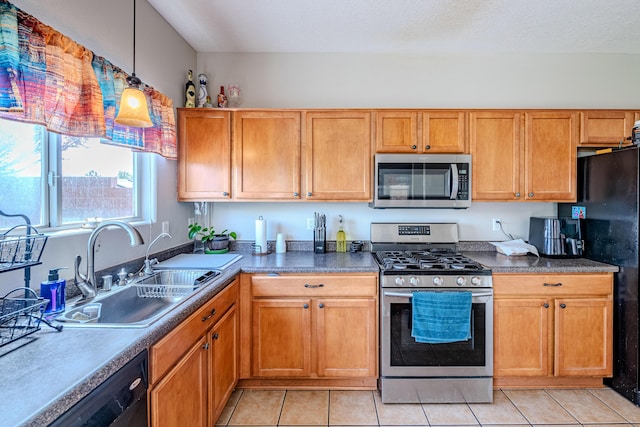 10500 Trieste Ct NW, Albuquerque, NM 87114 - kitchen featuring black appliances, a sink, light tile patterned floors, and brown cabinetry