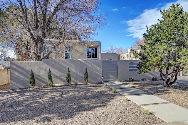 6507 Loftus Ave NE, Albuquerque, NM 87109 - view of property exterior with a gate, fence, and stucco siding