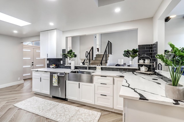 6507 Loftus Ave NE, Albuquerque, NM 87109 - kitchen featuring a sink, stainless steel dishwasher, white cabinetry, decorative backsplash, and recessed lighting