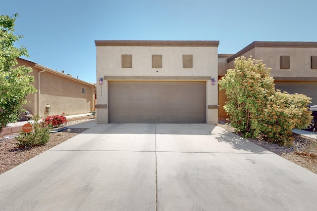 3136 Morrissey St SW, Albuquerque, NM 87121 - adobe home featuring driveway, stucco siding, and a garage