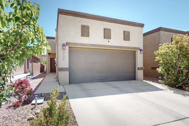 3136 Morrissey St SW, Albuquerque, NM 87121 - view of front of home with stucco siding, a garage, and concrete driveway
