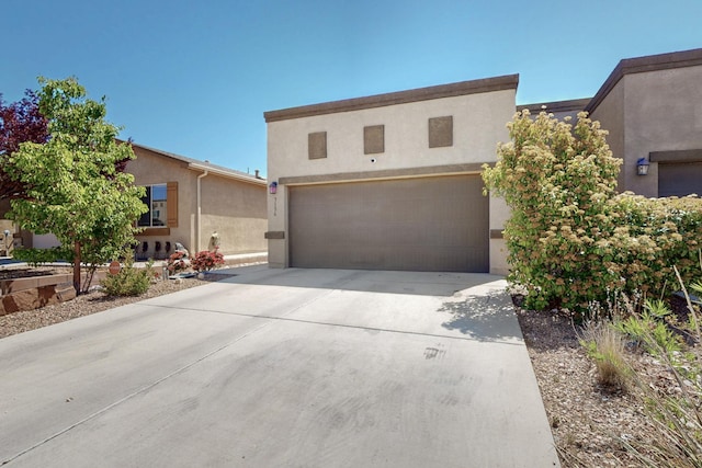 3136 Morrissey St SW, Albuquerque, NM 87121 - view of front of house featuring driveway, stucco siding, and an attached garage