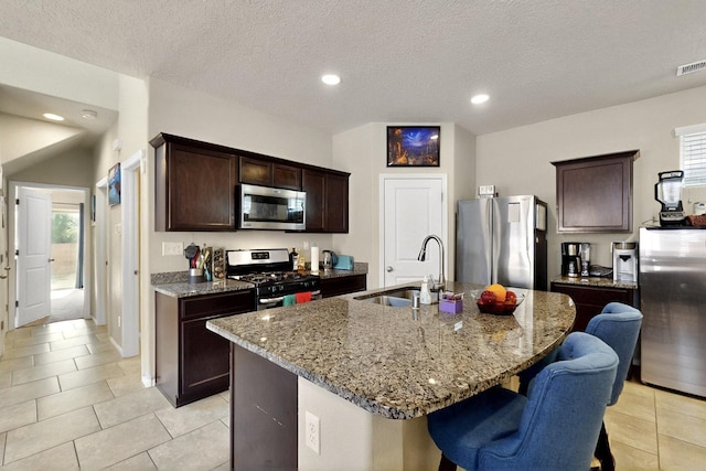 3136 Morrissey St SW, Albuquerque, NM 87121 - kitchen featuring stainless steel appliances, a sink, light tile patterned flooring, stone counters, and recessed lighting