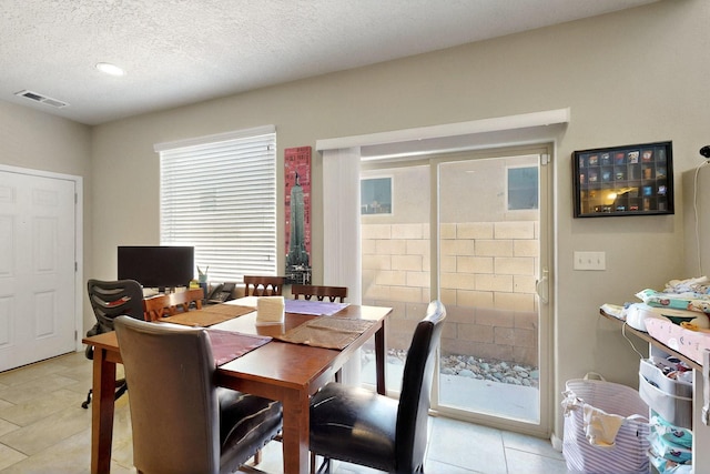 3136 Morrissey St SW, Albuquerque, NM 87121 - dining space featuring light tile patterned floors and a textured ceiling