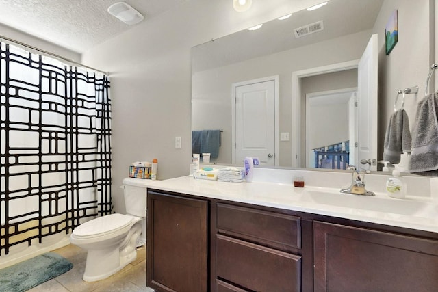 3136 Morrissey St SW, Albuquerque, NM 87121 - bathroom with vanity, tile patterned flooring, toilet, and a textured ceiling