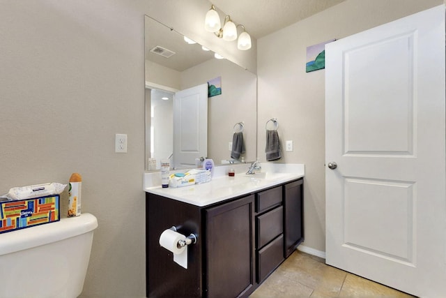 3136 Morrissey St SW, Albuquerque, NM 87121 - bathroom with toilet, vanity, and tile patterned floors