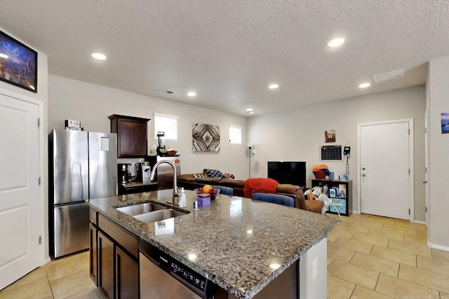 3136 Morrissey St SW, Albuquerque, NM 87121 - kitchen featuring a sink, stainless steel appliances, dark brown cabinets, recessed lighting, and dark stone countertops