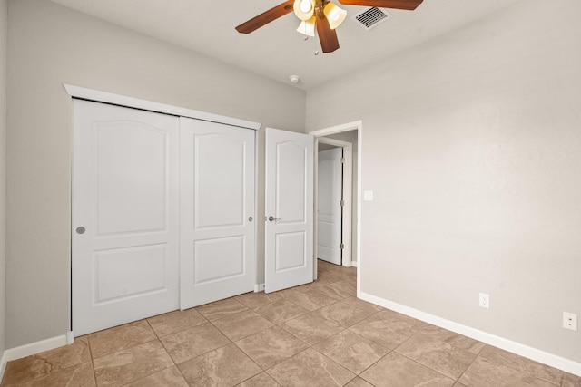 4909 Calle Espana NW, Albuquerque, NM 87120 - unfurnished bedroom with baseboards, a closet, and a ceiling fan