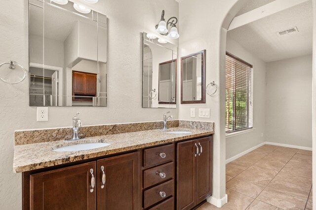 4909 Calle Espana NW, Albuquerque, NM 87120 - full bath featuring double vanity, tile patterned flooring, and baseboards