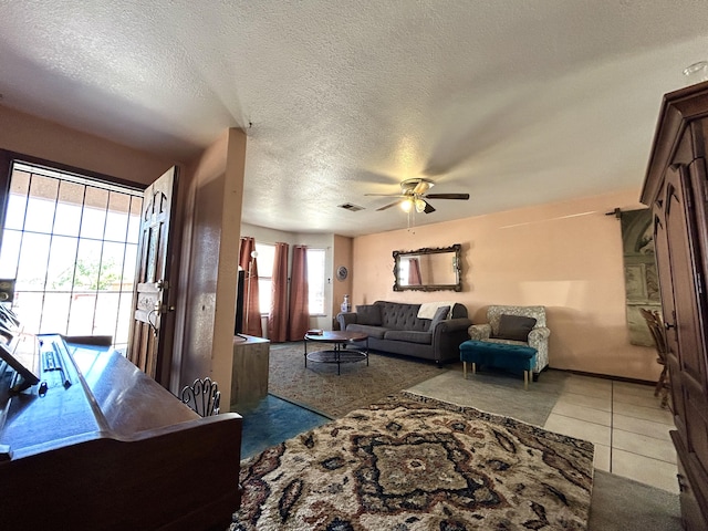 668 Helen Cir, Los Lunas, NM 87031 - tiled living room featuring a ceiling fan and a textured ceiling