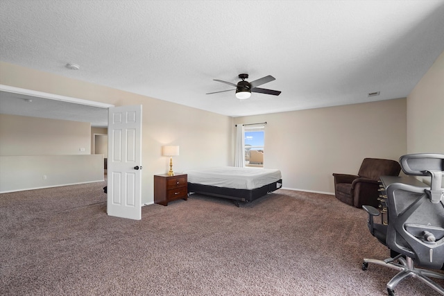 3129 Cochiti St NE, Rio Rancho, NM 87144 - bedroom featuring carpet, a ceiling fan, baseboards, and a textured ceiling
