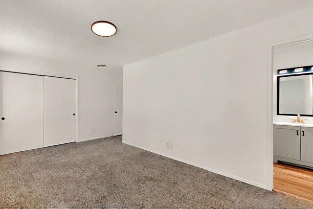357 Meade Ct, Rio Communities, NM 87002 - unfurnished bedroom featuring carpet, baseboards, a closet, and a sink