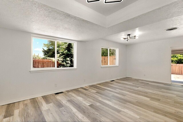 357 Meade Ct, Rio Communities, NM 87002 - empty room featuring light wood-type flooring, a textured ceiling, and baseboards