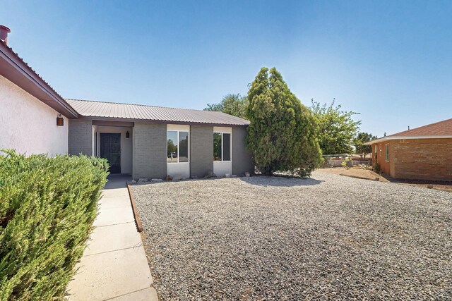 357 Meade Ct, Rio Communities, NM 87002 - back of house with brick siding and metal roof