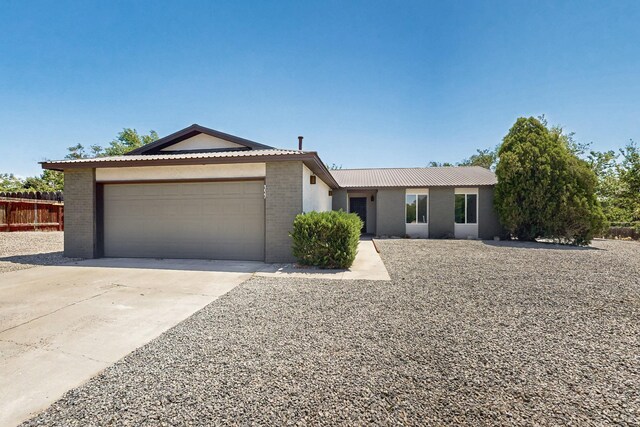 357 Meade Ct, Rio Communities, NM 87002 - single story home featuring an attached garage, brick siding, driveway, and fence