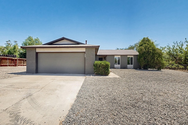 357 Meade Ct, Rio Communities, NM 87002 - single story home with fence, an attached garage, driveway, and brick siding