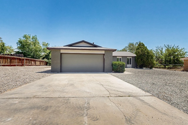 357 Meade Ct, Rio Communities, NM 87002 - view of front of house featuring concrete driveway, a garage, fence, and brick siding