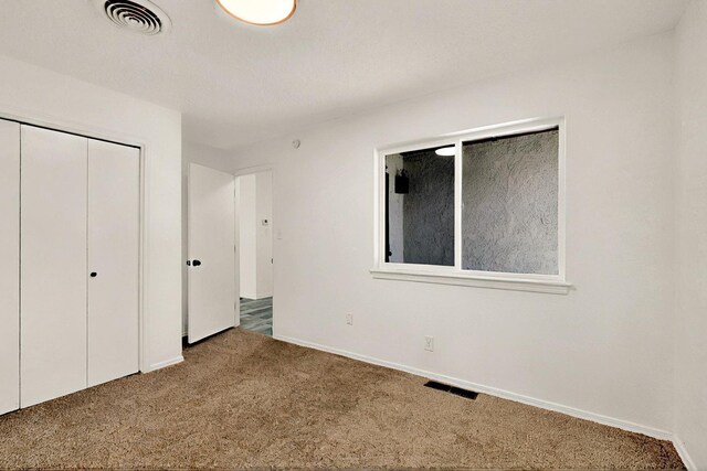 357 Meade Ct, Rio Communities, NM 87002 - unfurnished bedroom featuring carpet, a closet, and baseboards