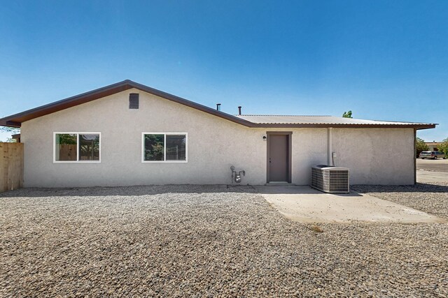 357 Meade Ct, Rio Communities, NM 87002 - back of property with stucco siding, central air condition unit, a patio, and fence