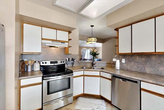 1952 Raspberry Dr NE, Rio Rancho, NM 87144 - kitchen with appliances with stainless steel finishes, under cabinet range hood, decorative backsplash, and white cabinets