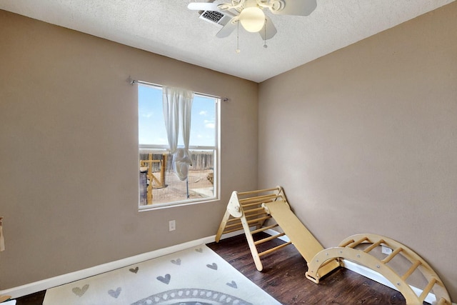 1952 Raspberry Dr NE, Rio Rancho, NM 87144 - playroom with a ceiling fan, baseboards, dark wood finished floors, and a textured ceiling