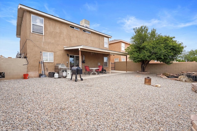 656 Cottontail St SW, Albuquerque, NM 87121 - rear view of house with stucco siding, a fenced backyard, a patio, and central AC unit