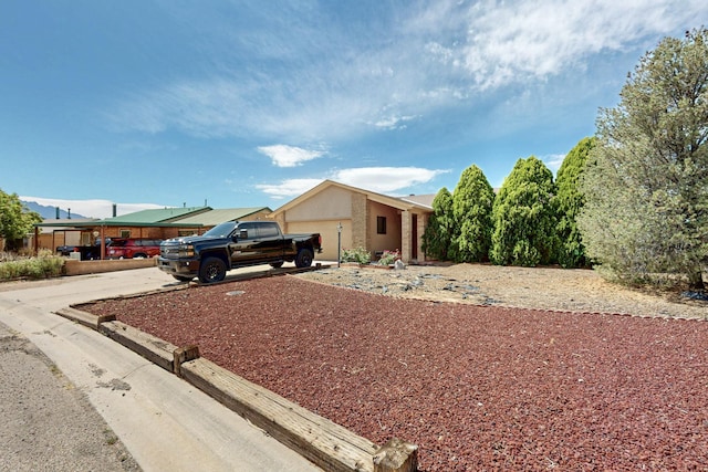 6242 Roadrunner Loop NE, Rio Rancho, NM 87144 - view of front facade with driveway, stucco siding, and an attached garage