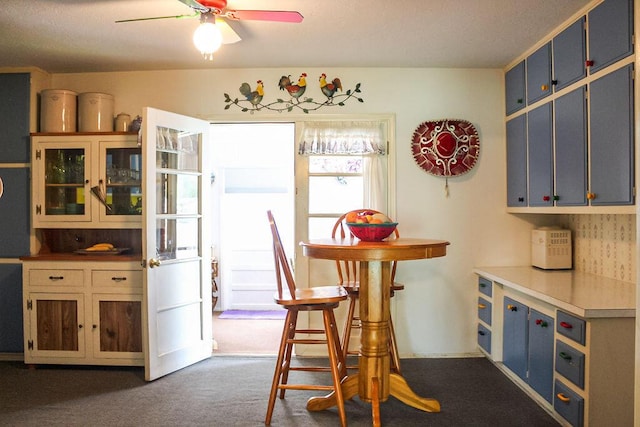 2701 Chapulin Rd SW, Albuquerque, NM 87105 - dining room with ceiling fan and dark colored carpet